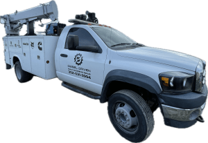 A white diesel service truck with a raised hydraulic lift, displaying the logo and contact information for Diesel Driven Heavy Equipment Repair.